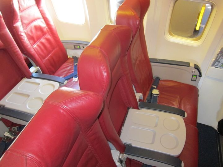 The only differences between the front two rows of premium economy and row 3 are the fold-down table and free choices from the in-flight menu.