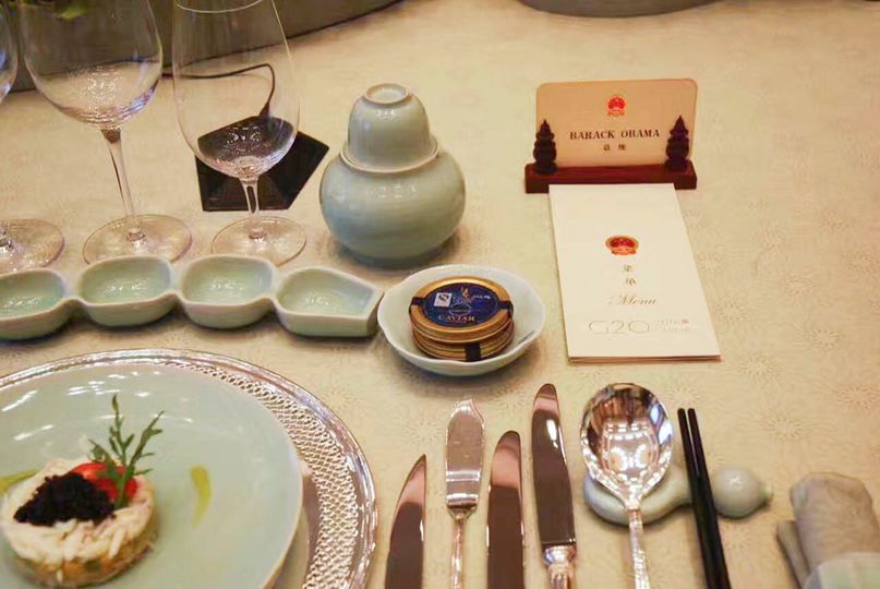 A tin of Kaluga Queen sits next to President Obama’s namecard during the 2016 G20 Summit