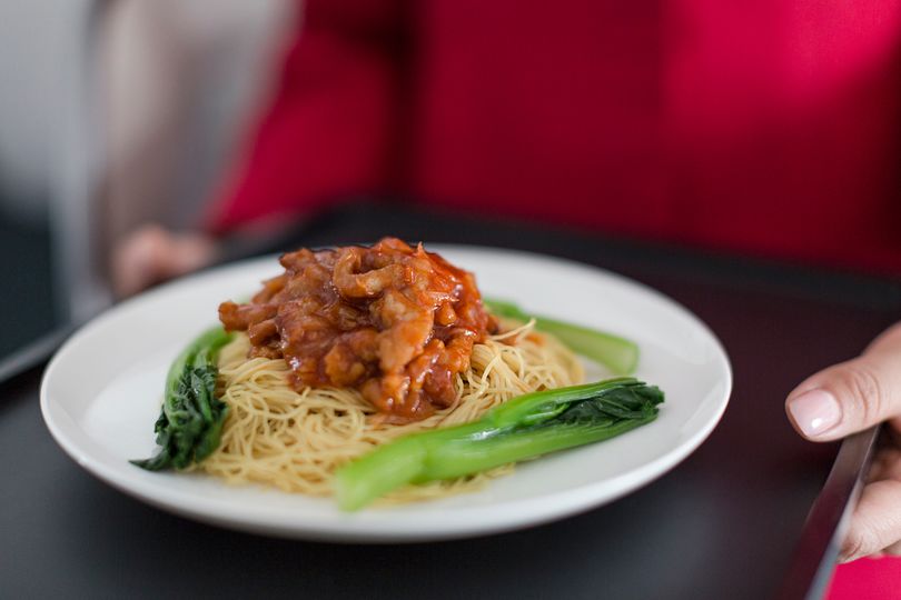 Stir fried pork and shallots in chilli tomato sauce on-egg noodles