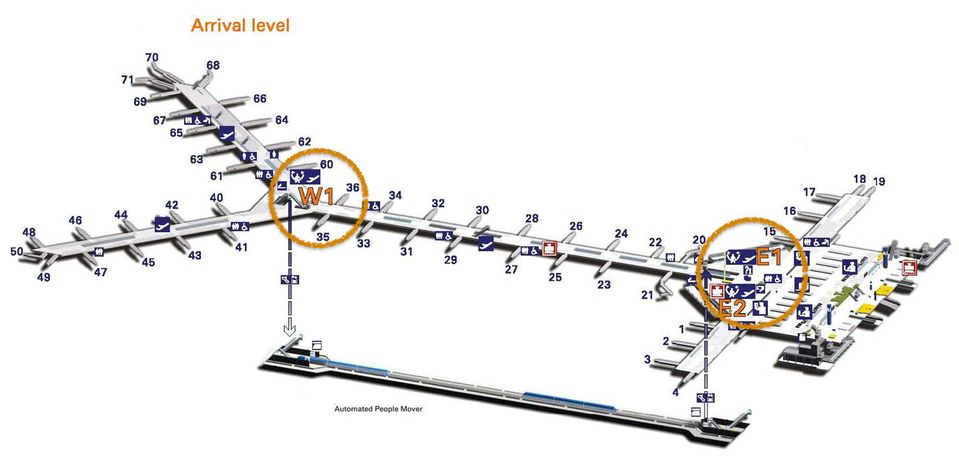 Transit desks at E2 and W1 circled. The Pier lounge is near Gate 65.