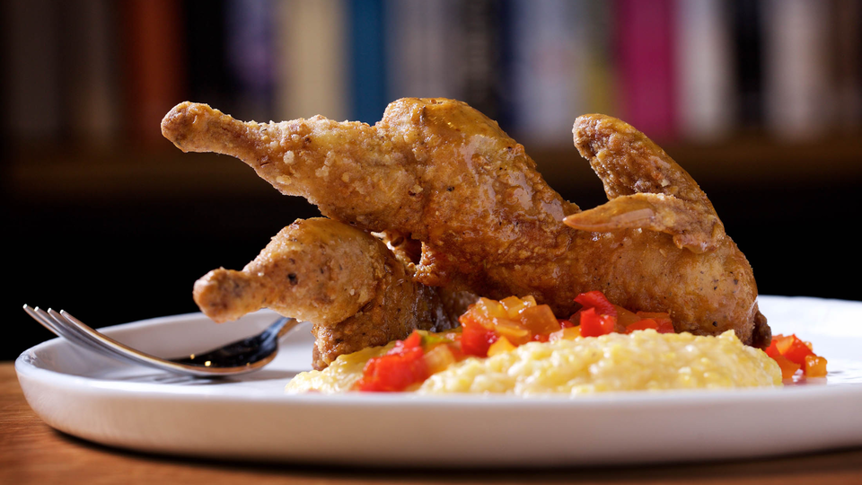 Quail, cheddar grits, pepper, and miso honey at Rooster & Owl.