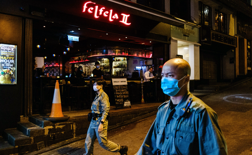 Riot police patrol the usually busy Lan Kwai Fong, a popular drinking area, in Hong Kong on March 23.