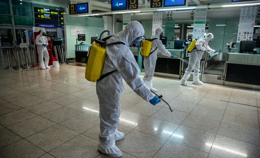 Members of Spain's military emergencies unit disinfect the check-in area at El Prat airport in Barcelona, on March 19.