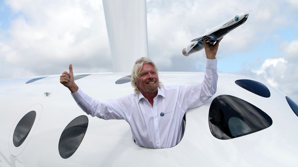 Richard Branson with a model of the LauncherOne rocket from the window of Virgin Galactic’s SpaceShipTwo at the Farnborough International Air Show in the U.K. in 2012.