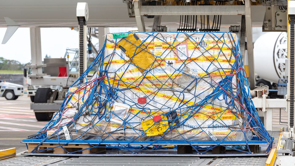 The first vaccine doses are unloaded from a Singapore Airlines Airbus A350 at Sydney Airport.. Sydney Airport