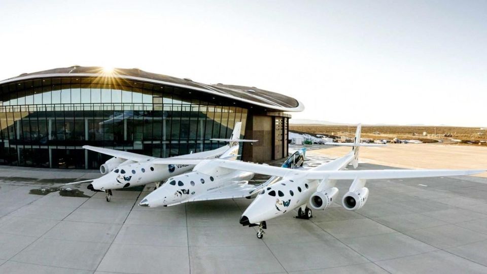 Virgin Galactic's VSS Unity sits beneath the VMS Eve launch platform outside the Spaceport America base.