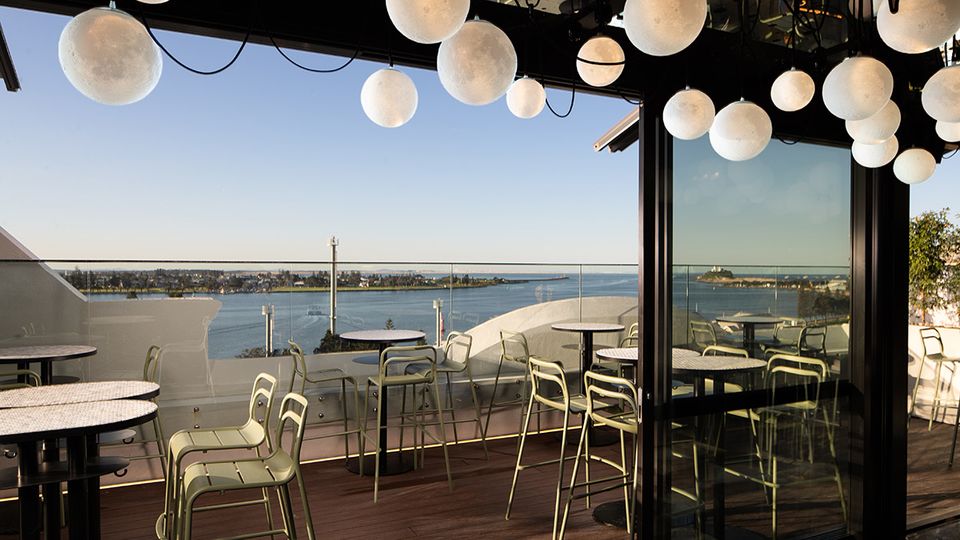 By day, Rooftop at QT enjoy sweeping views to Nobby's Lighthouse.