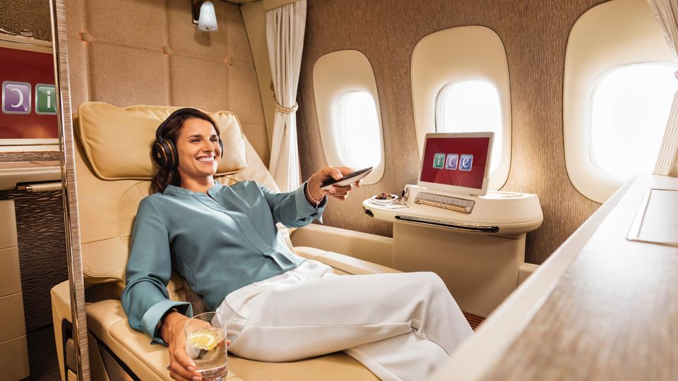 Emirates doesn't permit a points-based upgrade to first class if you hold an unbundled business class ticket.