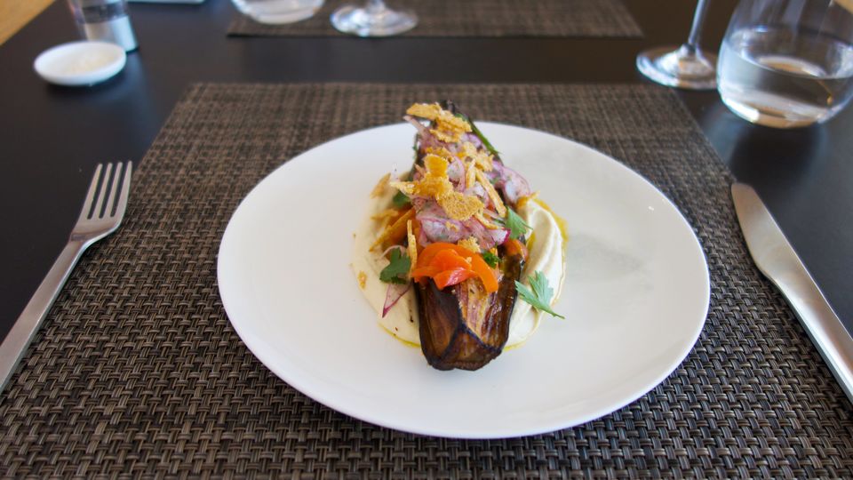 New to the Qantas First Lounge summer menu: crumbed eggplant with hummus, sumac onions and harissa.