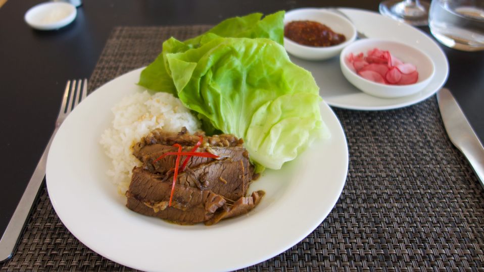 New to the Qantas First Lounge summer menu: jang jorim braised beef brisket with rice, ready to be wrapped into lettuce leaves with a fragrant doenjang sauce.