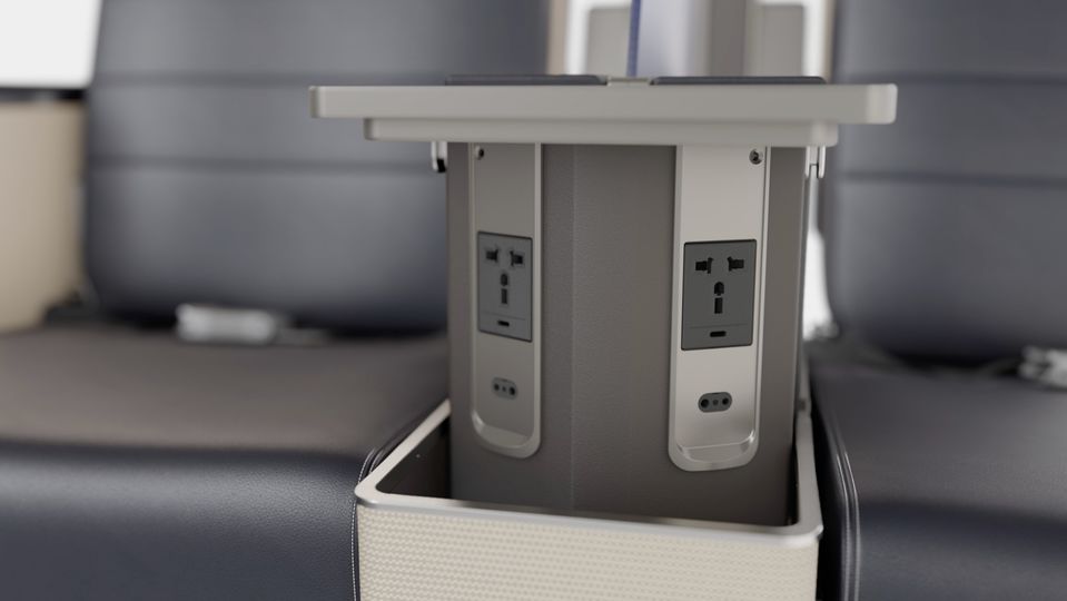 Power outlets are found between the seats, just above a nook for water bottles.
