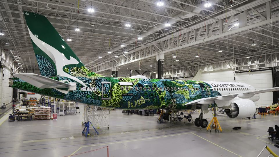 The first QantasLink A220, wrapped in its colourful Flying Art livery.