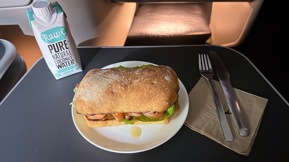 My mid-flight snack was this warmed BLT roll, with a coconut water to rehydrate.