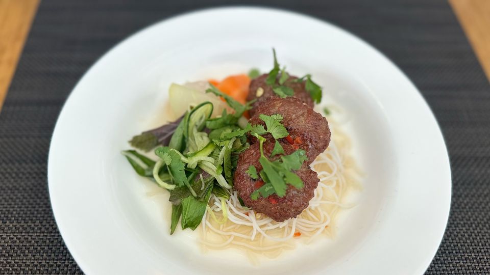 Grilled lemongrass pork patties with herb salad, coconut and chilli nuoc cham dressing.